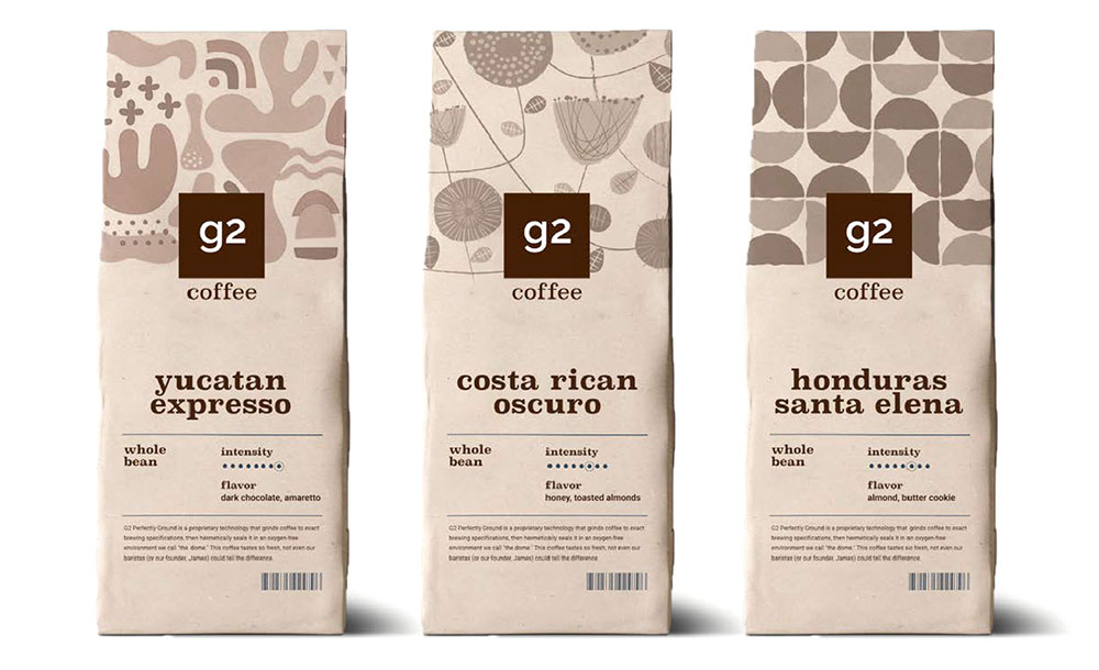 Three bags of g2 brand coffee beans are shown, displaying their eye-catching packaging that is also environmentally friendly.
